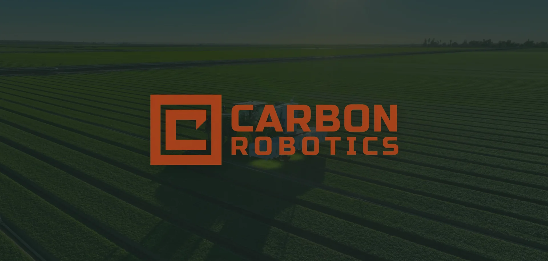 Carbon Robotics wordmark over an aerial view of a LaserWeeder in crop rows